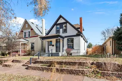 a white house with a black roof at Race St - Denver in Denver