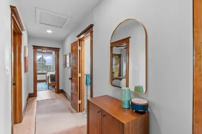 a bathroom with a wooden vanity and a mirror at Race St - Denver in Denver