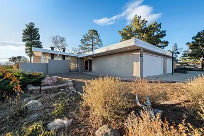 a house with a white garage in a yard at Lunceford - Northglenn in Northglenn