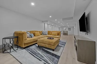 a living room with a couch and a flat screen tv at Carr - Lakewood in Lakewood