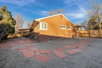 a house with red brick stepping stones in the driveway at Carr - Lakewood in Lakewood