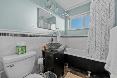a bathroom with a tub and a sink and a toilet at Carr - Lakewood in Lakewood