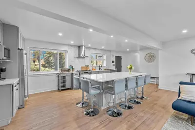 a kitchen with a large white table and chairs at Carr - Lakewood in Lakewood