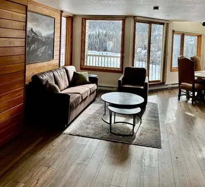 a living room with a couch and a table at Keystone Lakeside Condo in Keystone