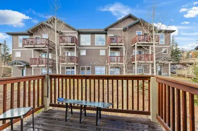 a deck with two chairs and a bench at 2BR Condo - Ideal Hub for Year-Round Fun in Silverthorne