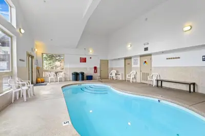 a pool in a large room with chairs and tables at 2BR Condo - Ideal Hub for Year-Round Fun in Silverthorne