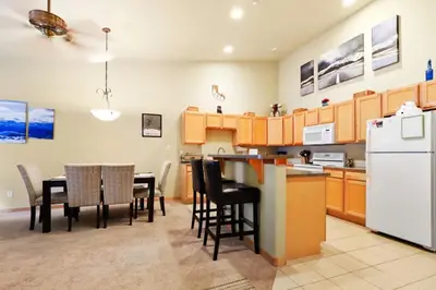a kitchen with a table and chairs and a refrigerator at 2BR Condo - Ideal Hub for Year-Round Fun in Silverthorne