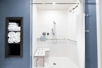 a bathroom with a shower and a white sink at Residence Inn by Marriott Arvada Denver West in Arvada