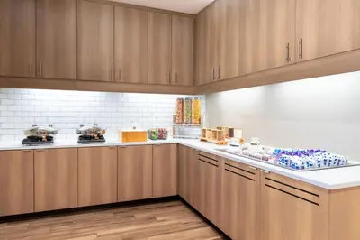 a kitchen with wooden cabinets and white counter tops at Residence Inn by Marriott Arvada Denver West in Arvada