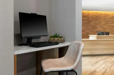 a computer sitting on a desk with a chair at Residence Inn by Marriott Arvada Denver West in Arvada