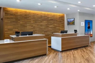 a lobby with two reception desks and a brick wall at Residence Inn by Marriott Arvada Denver West in Arvada