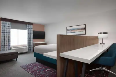 a hotel room with a bed and a desk at Hilton Garden Inn Denver Airport Tower Road in Denver