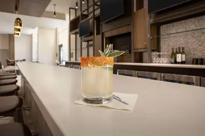 a drink sitting on a counter in a bar at Hilton Garden Inn Denver Airport Tower Road in Denver