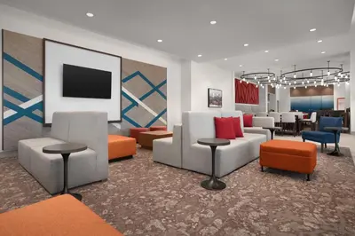 a lobby with couches and chairs and a table at Hilton Garden Inn Denver Airport Tower Road in Denver