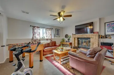 a living room with a couch and a fireplace at Loveland Home with Private Hot Tub and Wood Fireplace! in Loveland