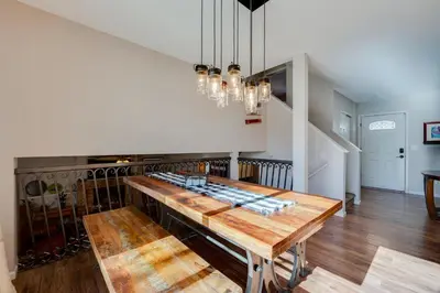 a dining room with a table and a chandelier at Loveland Home with Private Hot Tub and Wood Fireplace! in Loveland