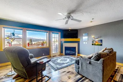 a living room with two chairs and a fireplace at La Rive Del Lago 302 in Dillon