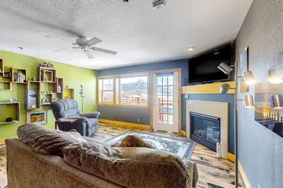 a living room with a couch and a fireplace at La Rive Del Lago 302 in Dillon