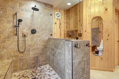 a bathroom with a shower and a toilet at Lake and Mtn Views Spectacular Grand Lake Home in Grand Lake