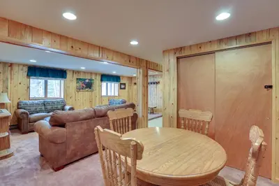 a living room with a table and a couch at Lake and Mtn Views Spectacular Grand Lake Home in Grand Lake