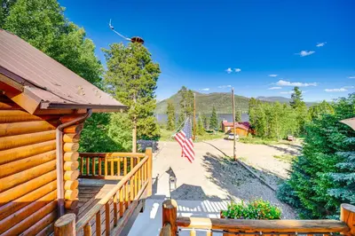 a cabin with an american flag on the porch at Lake and Mtn Views Spectacular Grand Lake Home in Grand Lake