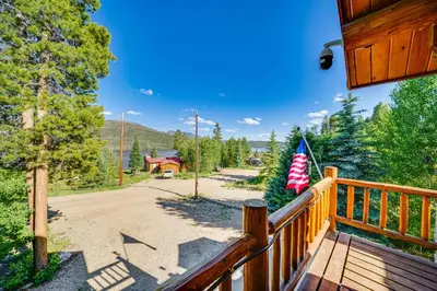 a porch of a house with an american flag at Lake and Mtn Views Spectacular Grand Lake Home in Grand Lake