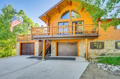 a log home with a deck and a garage at Lake and Mtn Views Spectacular Grand Lake Home in Grand Lake