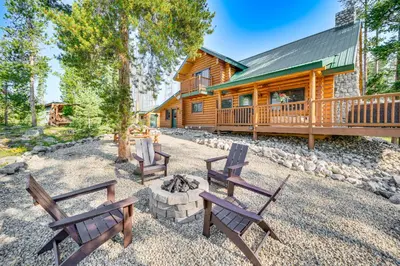 a cabin with benches and a fire pit in the yard at 4 Mi to Rocky Mtn Natl Park Cabin Near Town! in Grand Lake