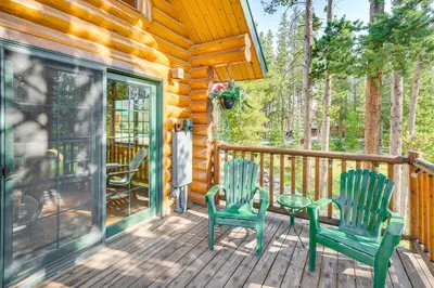 two chairs and a table on the porch of a cabin at 4 Mi to Rocky Mtn Natl Park Cabin Near Town! in Grand Lake