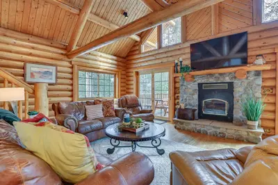 a living room with leather furniture and a fireplace at 4 Mi to Rocky Mtn Natl Park Cabin Near Town! in Grand Lake