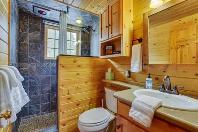 a bathroom with a toilet and a sink and a shower at 4 Mi to Rocky Mtn Natl Park Cabin Near Town! in Grand Lake