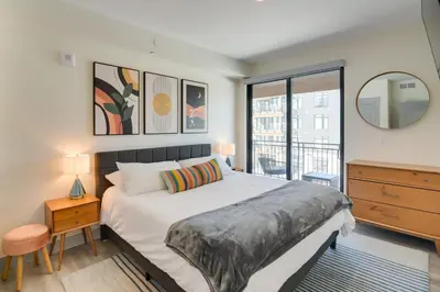 a bedroom with a large bed and a window at Winter Park Condo with Hot Tub, Balcony and Shuttle! in Winter Park