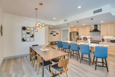 a kitchen and dining room with a wooden table and chairs at Winter Park Condo with Hot Tub, Balcony and Shuttle! in Winter Park
