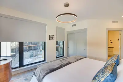 a bedroom with a bed and a large window at Winter Park Condo with Hot Tub, Balcony and Shuttle! in Winter Park