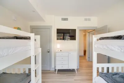 a bedroom with two bunk beds and a white dresser at Winter Park Condo with Hot Tub, Balcony and Shuttle! in Winter Park