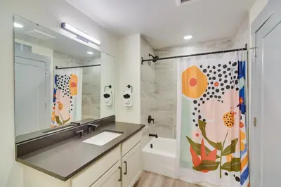 a bathroom with a sink and a shower curtain at Winter Park Condo with Hot Tub, Balcony and Shuttle! in Winter Park