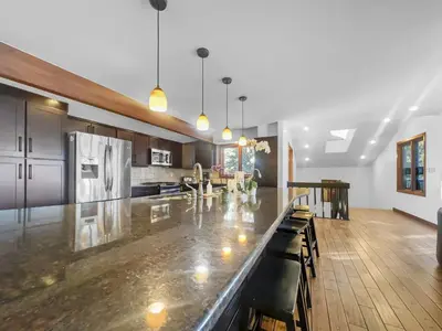 a large kitchen with a large marble counter top at 208 Tenderfoot 5Br 5Ba home in Dillon