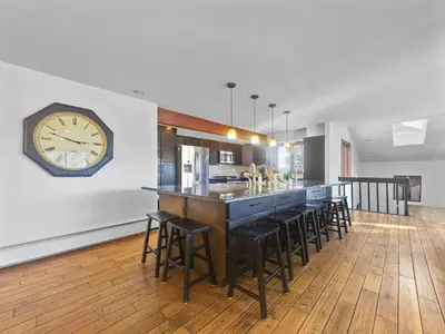 a large clock on a wall next to a bar at 208 Tenderfoot 5Br 5Ba home in Dillon