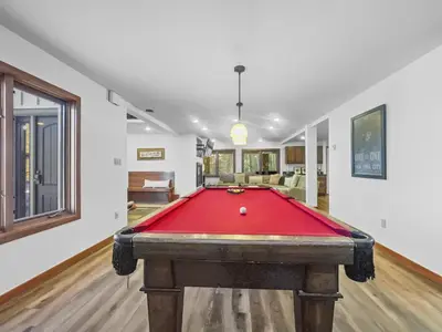 a pool table in the middle of a living room at 208 Tenderfoot 5Br 5Ba home in Dillon