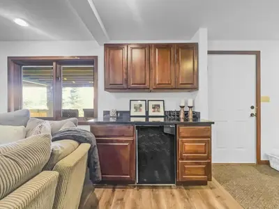 a living room with a couch and a kitchen at 208 Tenderfoot 5Br 5Ba home in Dillon
