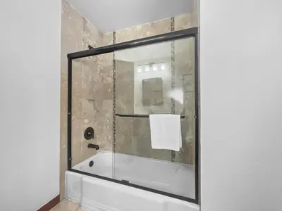 a bathroom with a shower with a glass door at 208 Tenderfoot 5Br 5Ba home in Dillon