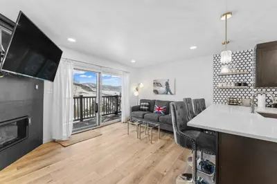 a kitchen and living room with a couch and a television at Summit Yacht Club 10: 2 in Dillon