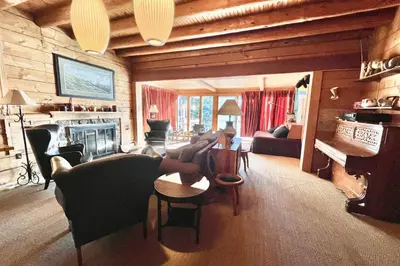 a living room filled with furniture and a fireplace at Davis Cabin, Historic Charmer in Grand Lake