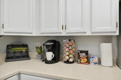 a kitchen counter with a coffeemaker and a coffee maker at NEW • Modern • 4BR • Game Rm • Ping-Pong in Arvada