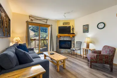 a living room with a couch and a fireplace at 2656 Tenderfoot Lodge condo in Keystone