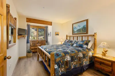 a bedroom with a bed and a television in it at 2656 Tenderfoot Lodge condo in Keystone
