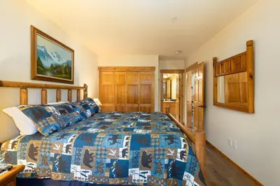 a bedroom with a bed with a colorful bedspread at 2656 Tenderfoot Lodge condo in Keystone