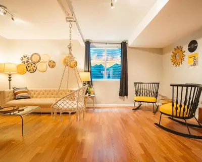a living room with a couch and chairs at Windsor Retreat Private Basement Suite in Denver