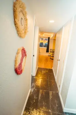 a hallway with two wreaths hanging on the wall at Windsor Retreat Private Basement Suite in Denver