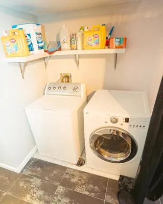 a small laundry room with a washing machine at Windsor Retreat Private Basement Suite in Denver